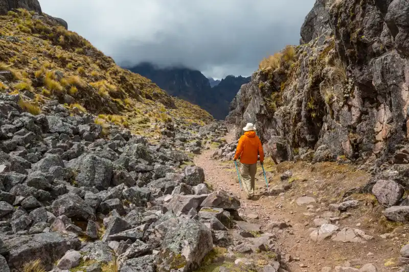 Hiker on a mountain trail in the Peruvian Andes