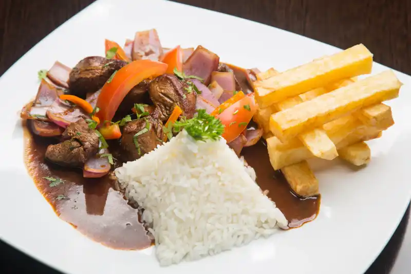 Lomo saltado with fries and rice